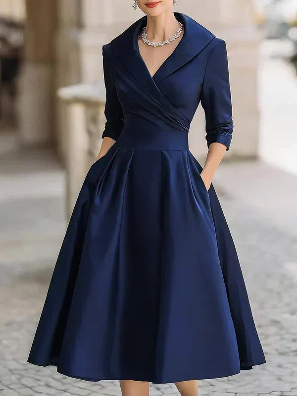 Elegant Midi Dress with Refined Details and Practical Pockets